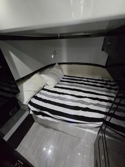 Lady Mash Yacht Photos Pics 2021 HCB 65 Estrella cabin with striped bedding and modern interior design.