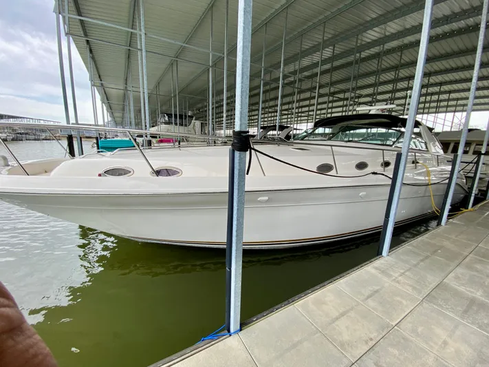  Yacht Photos Pics 1996 Sea Ray 450 Sundancer docked in a covered marina.