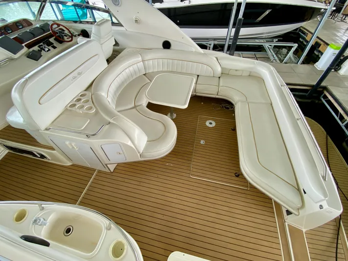  Yacht Photos Pics 1996 Sea Ray 450 Sundancer interior with white leather seating and wooden flooring.