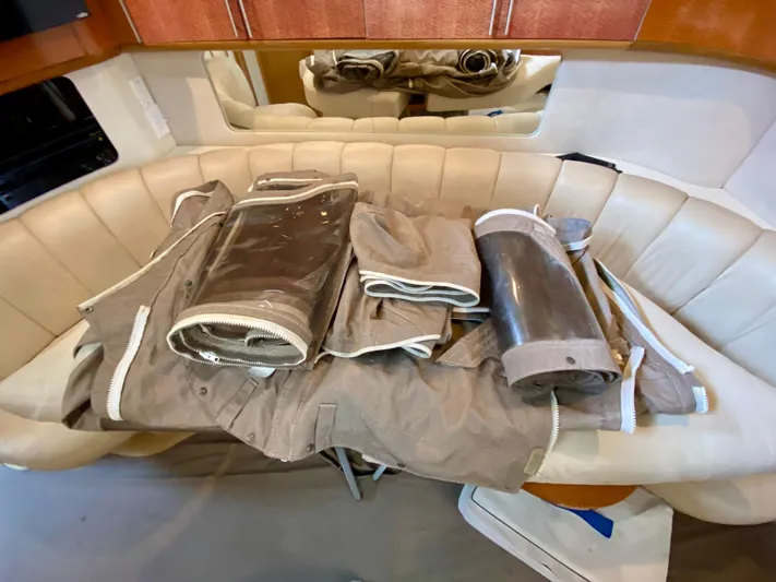  Yacht Photos Pics 1996 Sea Ray 450 Sundancer interior with beige seating and rolled canvas covers.