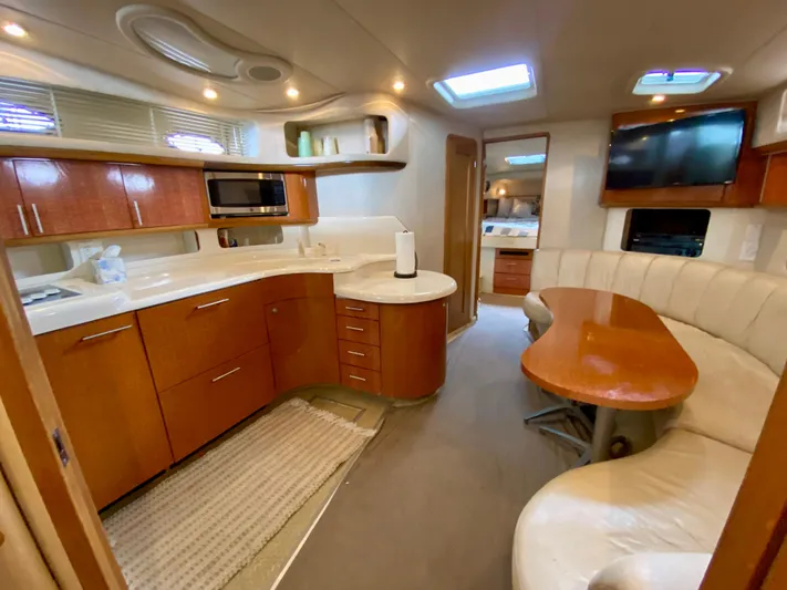  Yacht Photos Pics Luxurious interior of a 1996 Sea Ray 450 Sundancer yacht with modern kitchen and seating area.