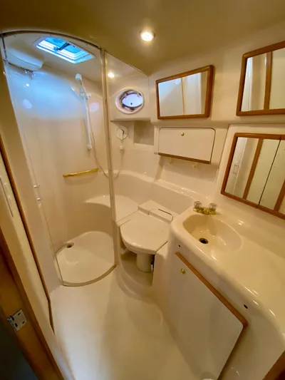  Yacht Photos Pics 1996 Sea Ray 450 Sundancer bathroom with shower, sink, and mirrors.