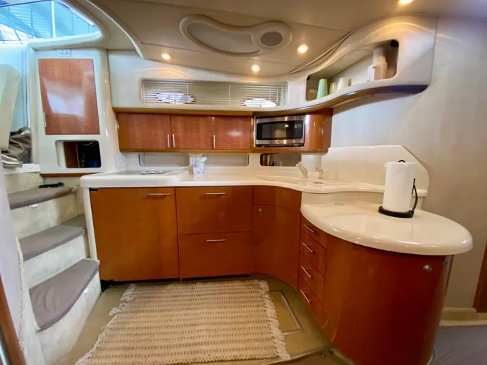  Yacht Photos Pics Interior of 1996 Sea Ray 450 Sundancer yacht kitchen with wood cabinets and modern appliances.