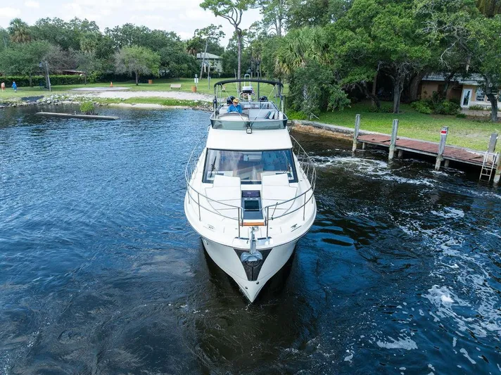 Have Another Yacht Photos Pics 2016 Beneteau Monte Carlo 4 yacht cruising on a serene lake near a wooded shoreline.