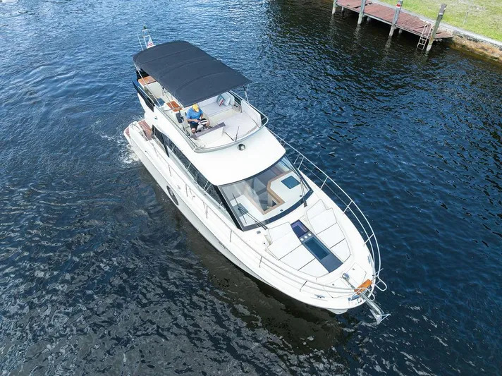 Have Another Yacht Photos Pics 2016 Beneteau Monte Carlo 4 yacht cruising on a calm river near a dock.