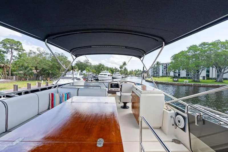 Have Another Yacht Photos Pics 2016 Beneteau Monte Carlo 4 yacht interior with seating and table, docked by a scenic waterfront.