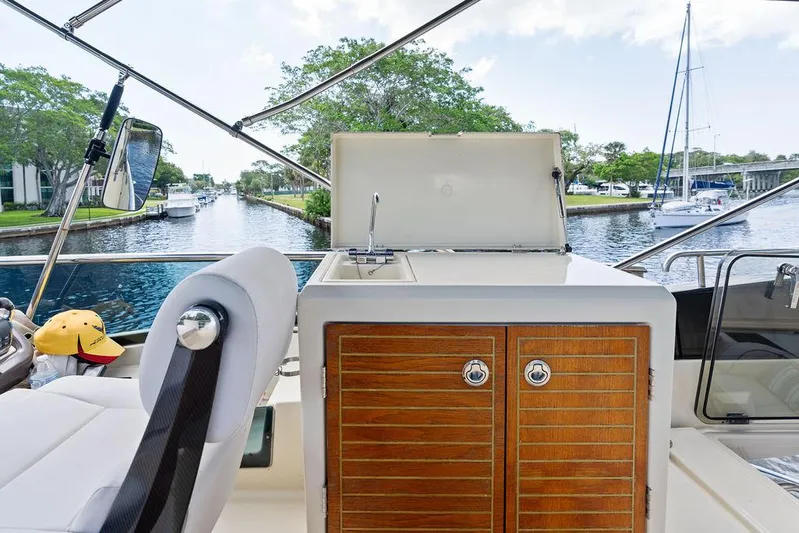 Have Another Yacht Photos Pics 2016 Beneteau Monte Carlo 4 yacht with outdoor sink and storage, docked on a scenic canal.