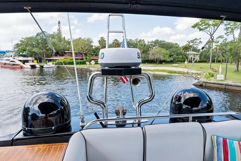 Have Another Yacht Photos Pics 2016 Beneteau Monte Carlo 4 yacht, rear view, docked by a scenic waterfront.