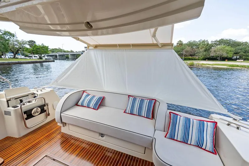 Have Another Yacht Photos Pics 2016 Beneteau Monte Carlo 4 yacht deck with cushioned seating and striped pillows.