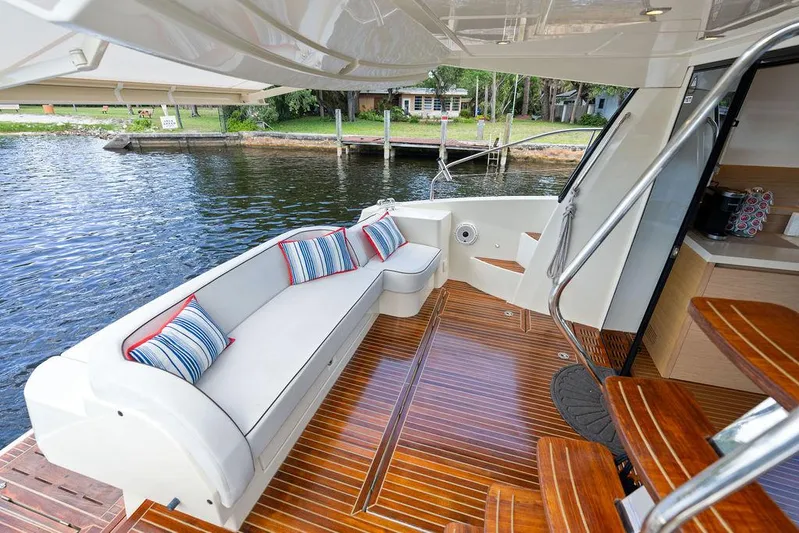 Have Another Yacht Photos Pics Luxurious 2016 Beneteau Monte Carlo 4 yacht deck with elegant seating and scenic waterfront view.