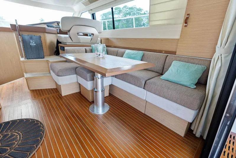 Have Another Yacht Photos Pics Interior of 2016 Beneteau Monte Carlo 4 yacht with elegant seating and wooden flooring.