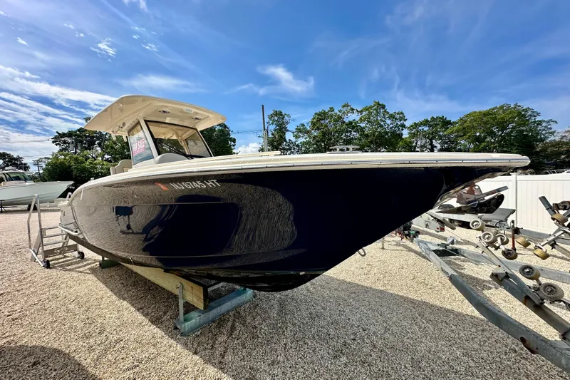  Yacht Photos Pics 2024 Scout 277 LXF boat on display under a clear blue sky.