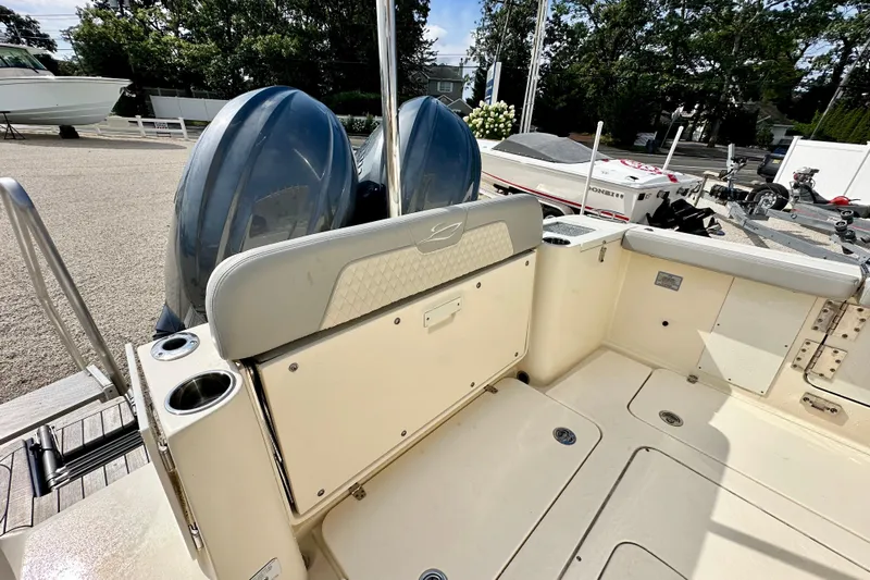  Yacht Photos Pics 2024 Scout 277 LXF boat interior with dual engines and seating area.