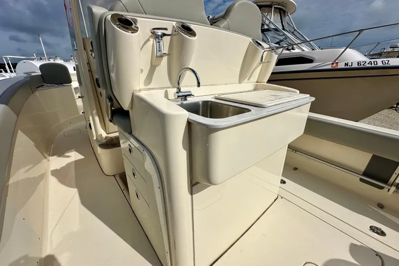  Yacht Photos Pics 2024 Scout 277 LXF boat interior with sink and storage compartments.
