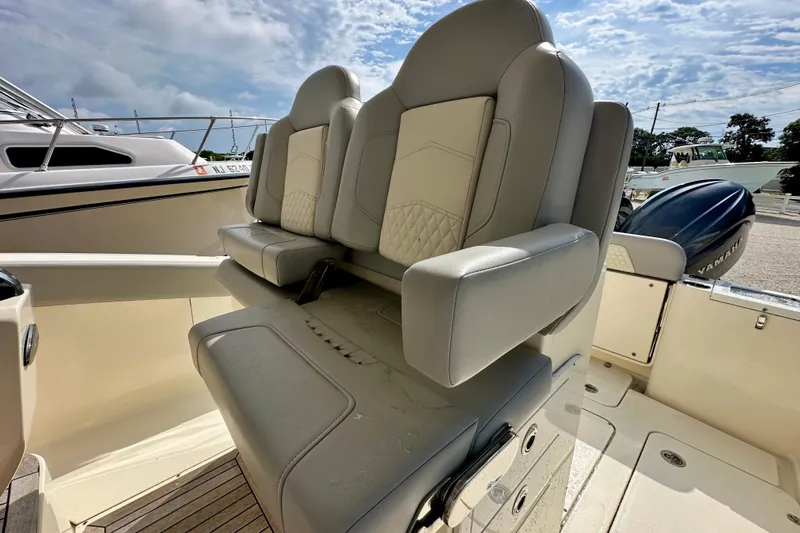  Yacht Photos Pics 2024 Scout 277 LXF boat interior with luxurious seating and Yamaha engine.