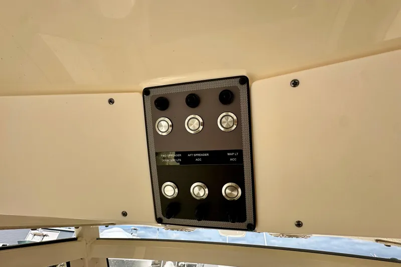  Yacht Photos Pics 2024 Scout 277 LXF boat control panel with labeled switches.