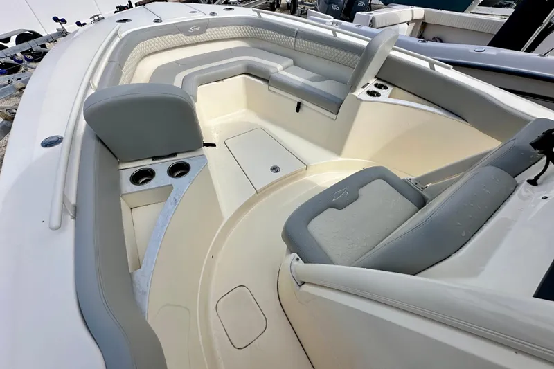  Yacht Photos Pics 2024 Scout 277 LXF boat interior with gray seating and cup holders.