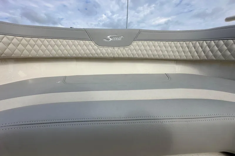  Yacht Photos Pics 2024 Scout 277 LXF boat interior with quilted gray seating and logo.