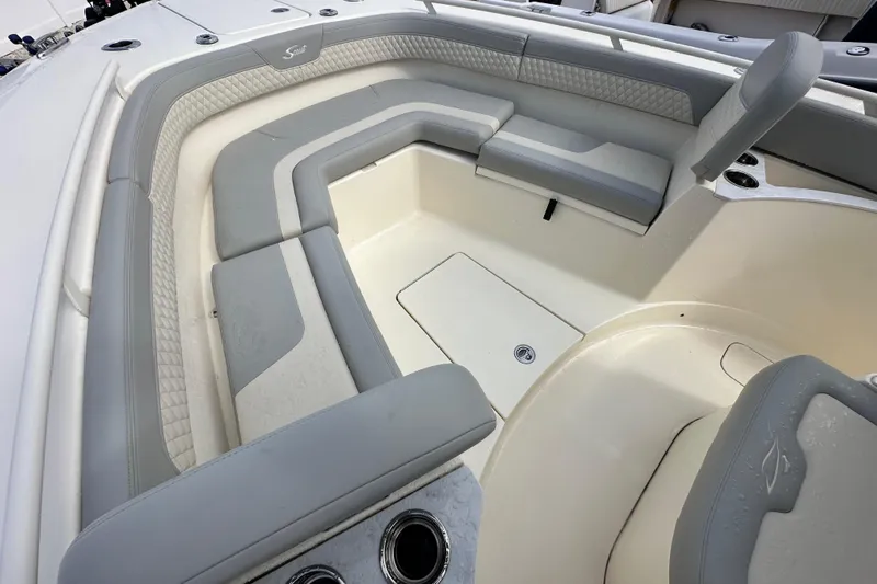 Yacht Photos Pics 2024 Scout 277 LXF boat interior with cushioned seating and storage compartments.