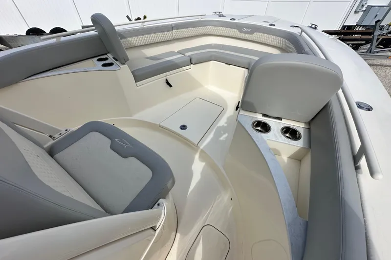  Yacht Photos Pics 2024 Scout 277 LXF boat interior with gray seating and cup holders.
