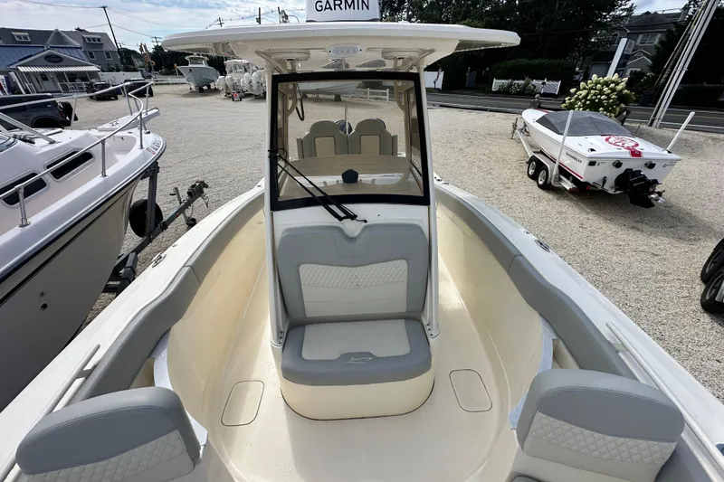  Yacht Photos Pics 2024 Scout 277 LXF boat interior with seating and Garmin navigation system.