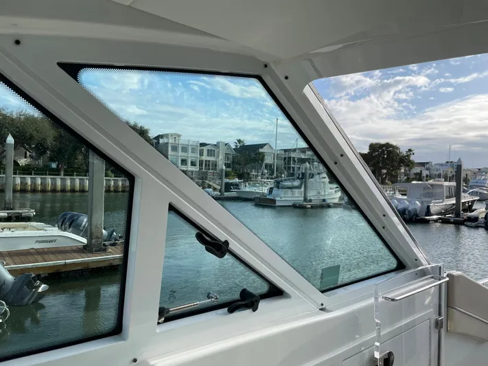  Yacht Photos Pics View from 2019 Formula 400 SSC boat window overlooking marina with boats and waterfront buildings.