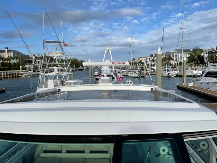  Yacht Photos Pics 2019 Formula 400 SSC yacht docked in a marina with clear skies and surrounding boats.