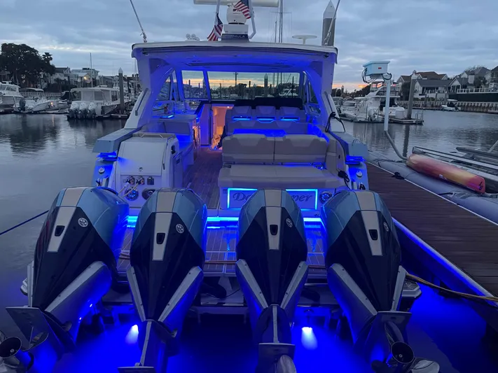  Yacht Photos Pics 2019 Formula 400 SSC boat with illuminated deck and four powerful engines at a marina.