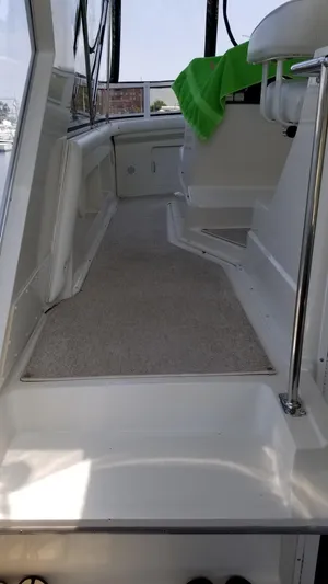  Yacht Photos Pics 1998 Carver 445 Aft Cabin Motor Yacht interior with carpeted walkway and seating.