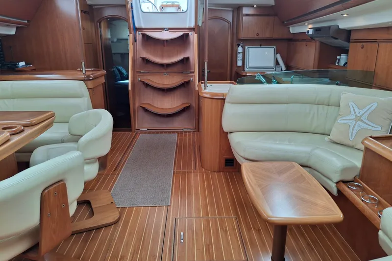 Majestic Yacht Photos Pics Luxurious interior of 2009 Jeanneau Sun Odyssey 54 DS yacht with wooden furnishings.