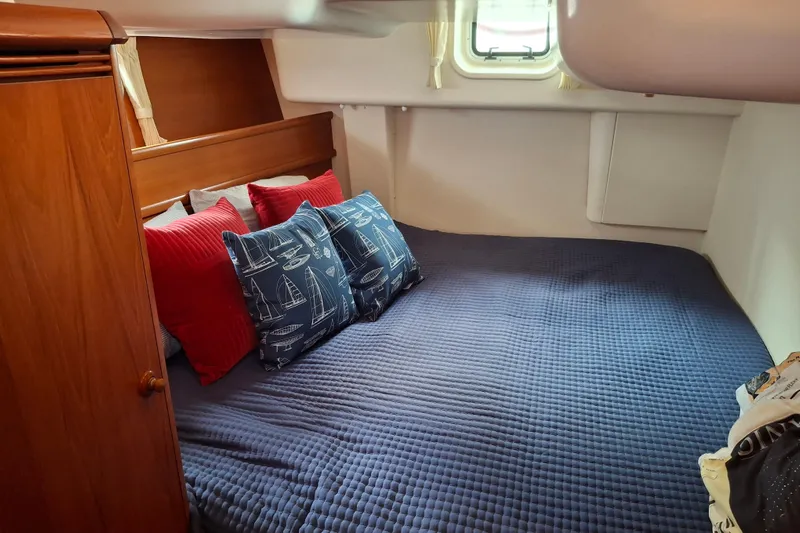 Majestic Yacht Photos Pics Cozy cabin interior of 2009 Jeanneau Sun Odyssey 54 DS with nautical-themed pillows.