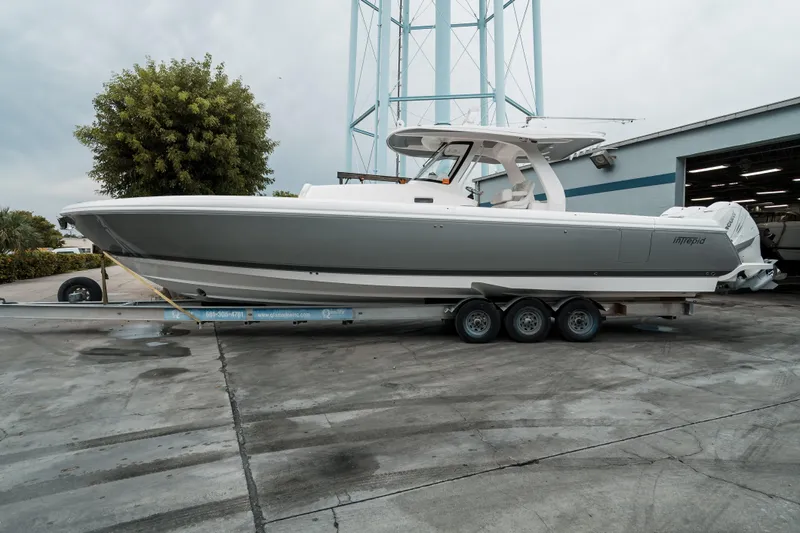 Tighten Up Yacht Photos Pics 2020 Intrepid 407 Panacea boat on trailer, parked outdoors near a building.