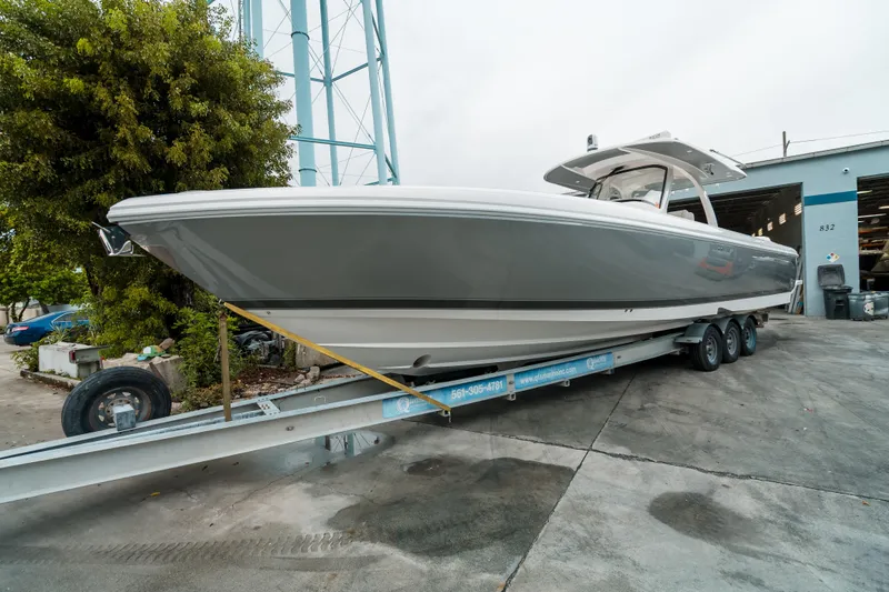 Tighten Up Yacht Photos Pics 2020 Intrepid 407 Panacea boat on trailer, parked outdoors near a building.