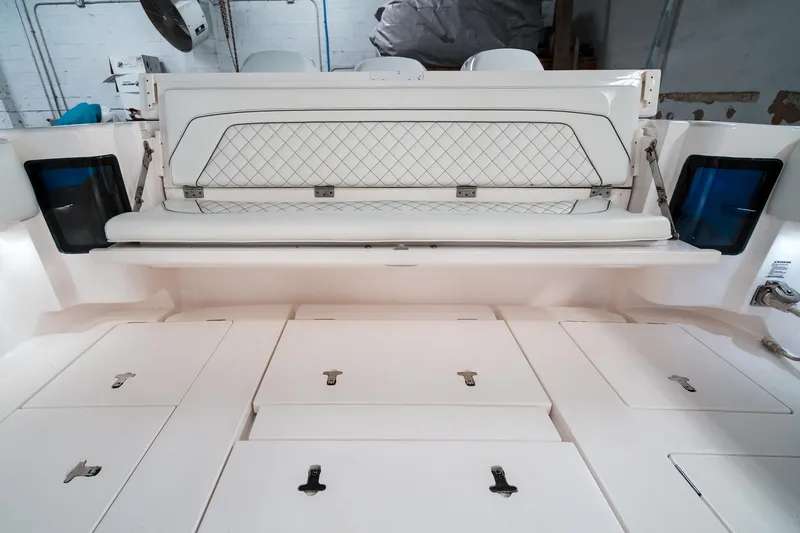 Tighten Up Yacht Photos Pics 2020 Intrepid 407 Panacea boat interior with white seating and storage compartments.