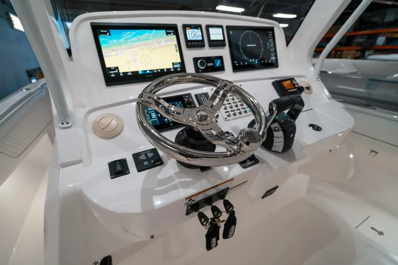 Tighten Up Yacht Photos Pics Control panel of 2020 Intrepid 407 Panacea boat with advanced navigation displays and steering wheel.