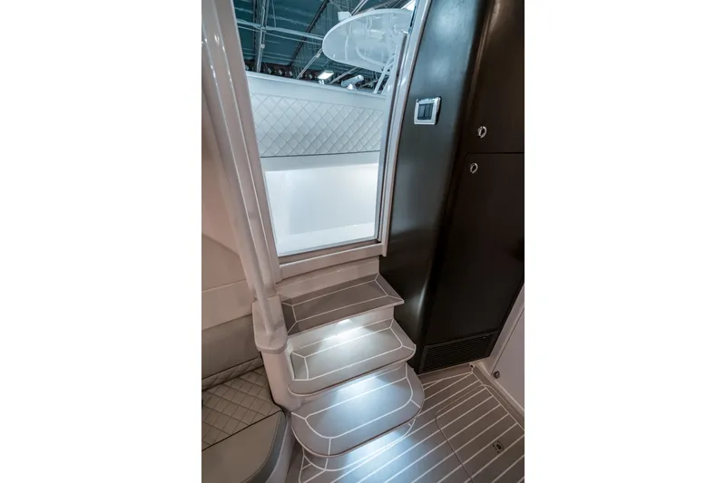 Tighten Up Yacht Photos Pics Interior stairs of 2020 Intrepid 407 Panacea yacht, featuring modern design and lighting.