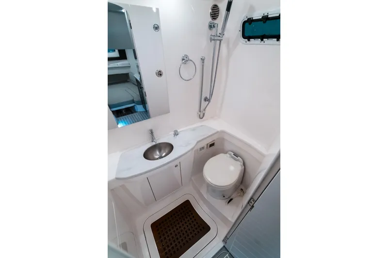Tighten Up Yacht Photos Pics 2020 Intrepid 407 Panacea boat bathroom with sink, toilet, and shower.
