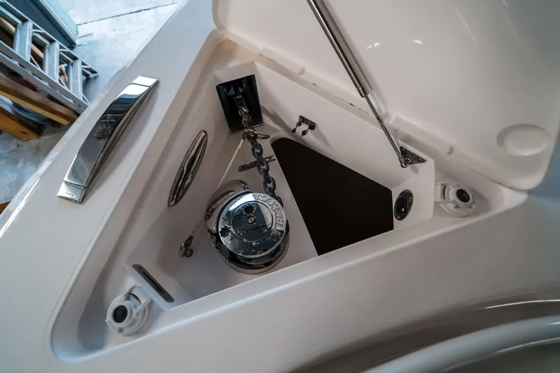 Tighten Up Yacht Photos Pics Anchor compartment of 2020 Intrepid 407 Panacea boat, featuring a polished metal winch.