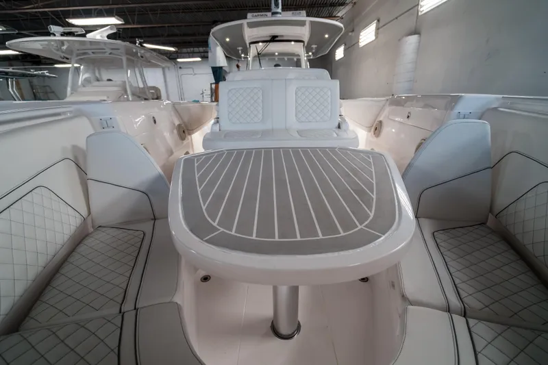 Tighten Up Yacht Photos Pics 2020 Intrepid 407 Panacea boat interior with elegant seating and table design.
