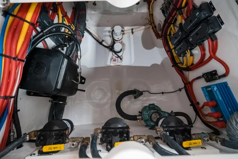Tighten Up Yacht Photos Pics Engine compartment of a 2020 Intrepid 407 Panacea with colorful wiring and components.