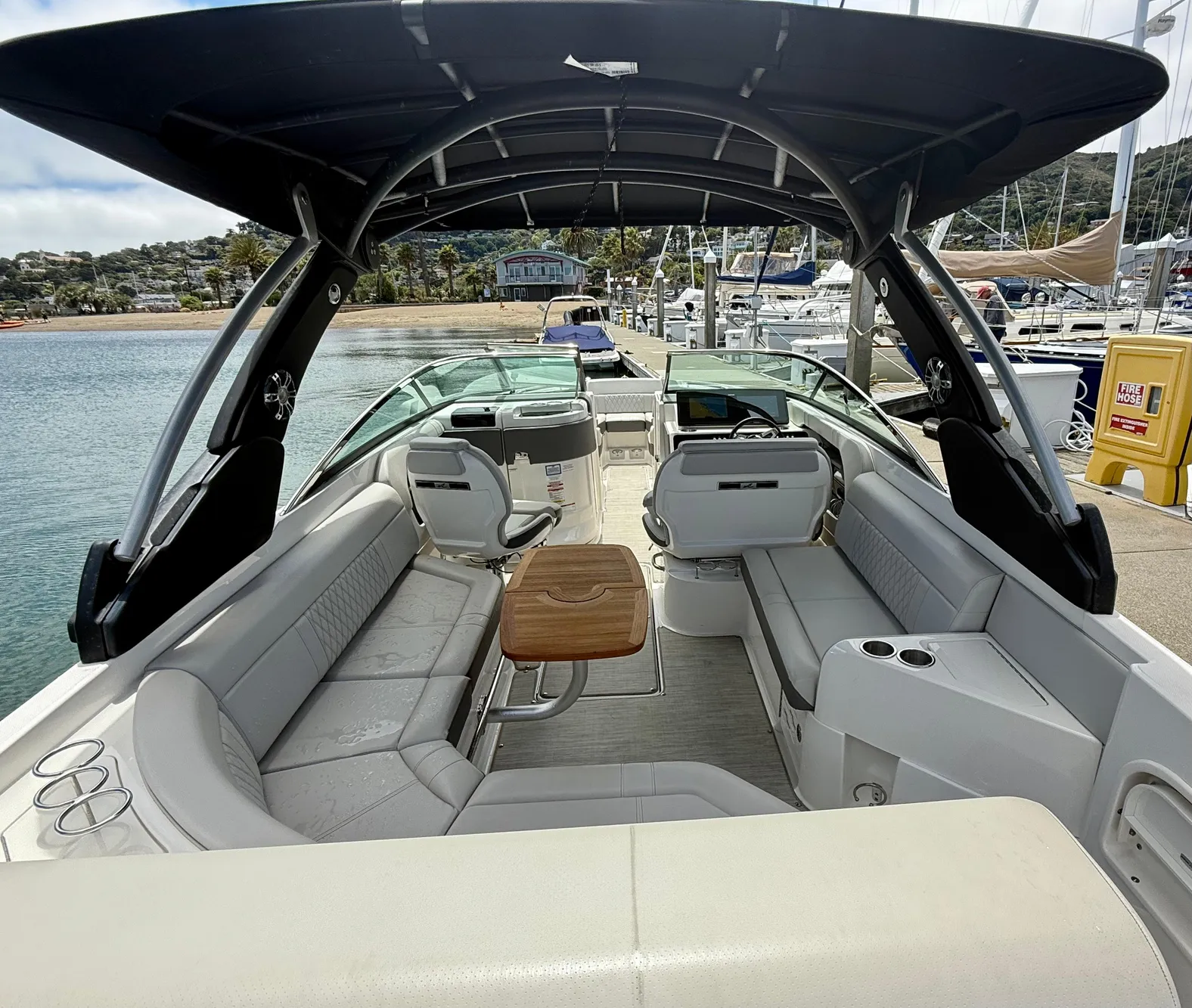 2020 Sea Ray SLX 280 boat interior with seating and table, docked at marina.