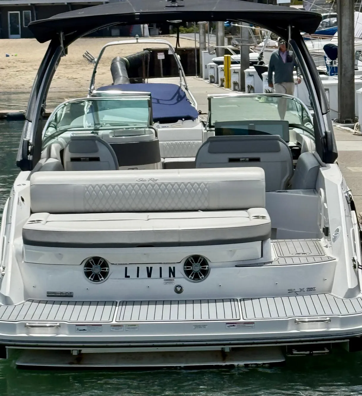 2020 Sea Ray SLX 280 boat docked, rear view with seating and "LIVIN" nameplate.