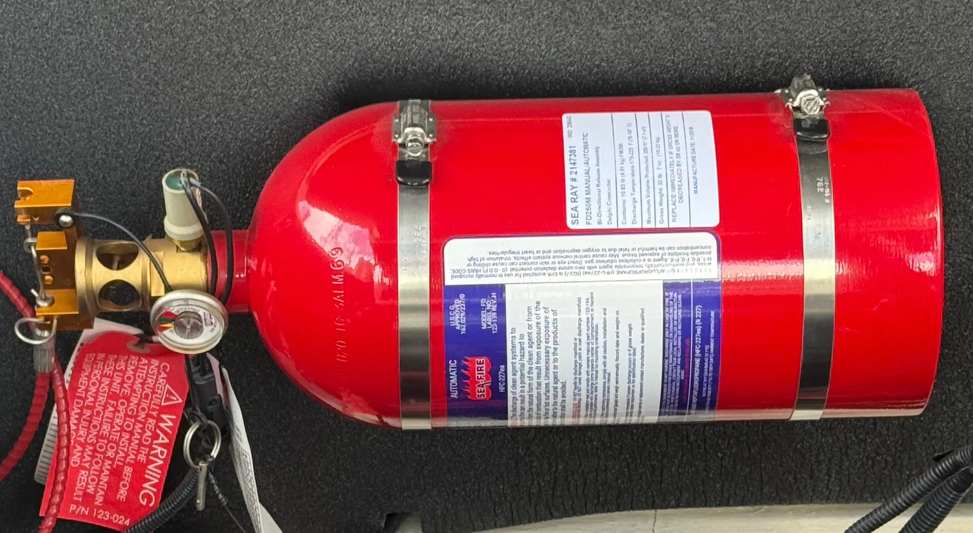 Red fire extinguisher mounted on a 2020 Sea Ray SLX 280 boat.