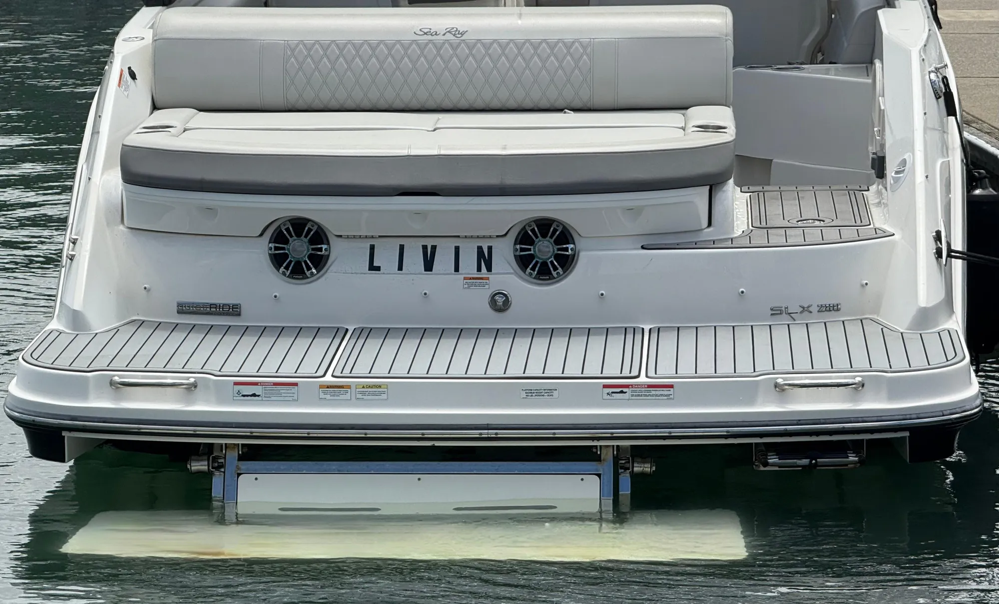2020 Sea Ray SLX 280 boat rear view with "LIVIN" nameplate on water.