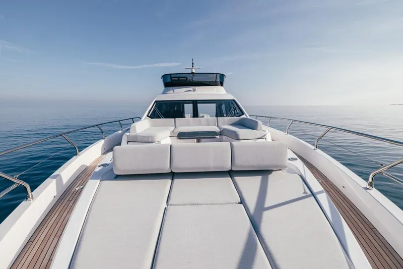  Yacht Photos Pics 2023 Azimut S7 yacht with luxurious deck seating on calm ocean waters.