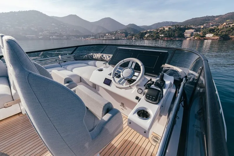  Yacht Photos Pics 2023 Azimut S7 yacht helm with luxurious seating and scenic coastal backdrop.