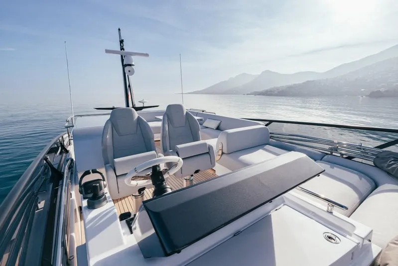  Yacht Photos Pics 2023 Azimut S7 yacht deck with luxurious seating, overlooking serene ocean and distant mountains.