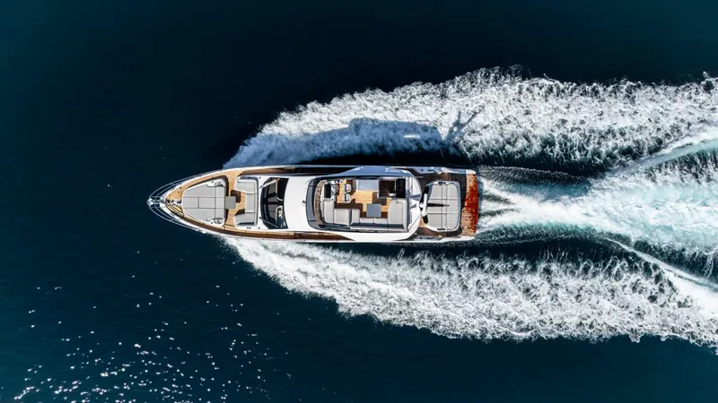  Yacht Photos Pics Aerial view of 2023 Azimut S7 yacht cruising on open water, leaving a wake behind.