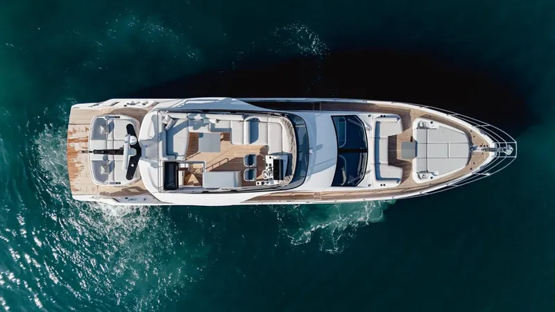  Yacht Photos Pics Aerial view of 2023 Azimut S7 luxury yacht cruising on clear blue water.