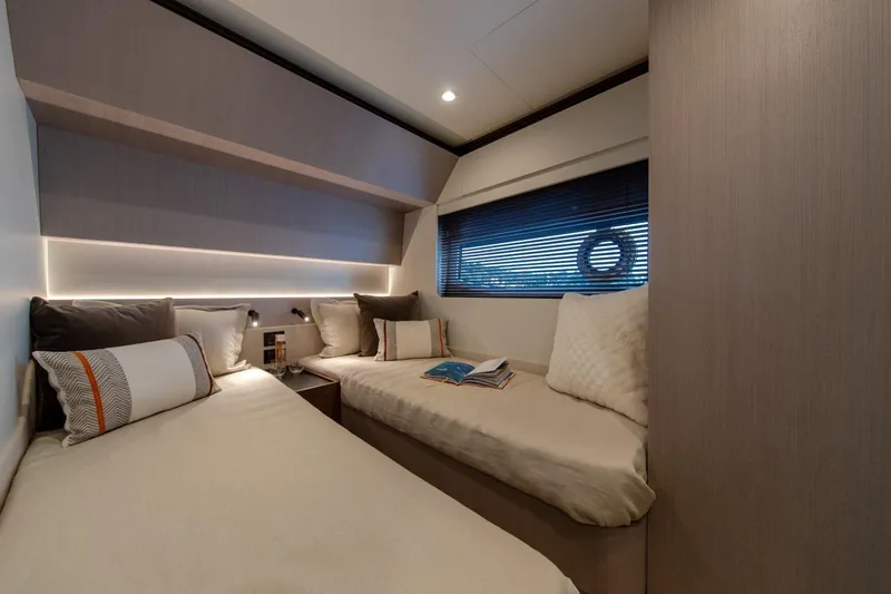  Yacht Photos Pics Luxurious 2023 Azimut S7 yacht cabin with twin beds and modern decor.